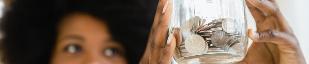 Woman holding a jar with coins